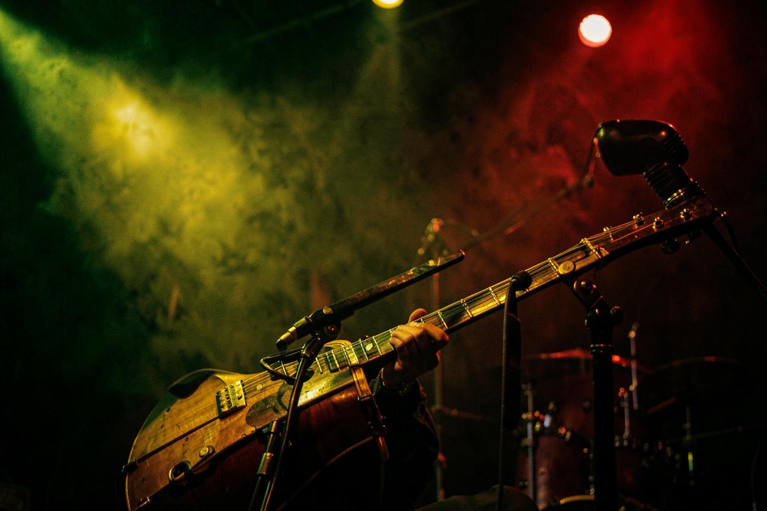 Guitar and microphone on an intimate stage